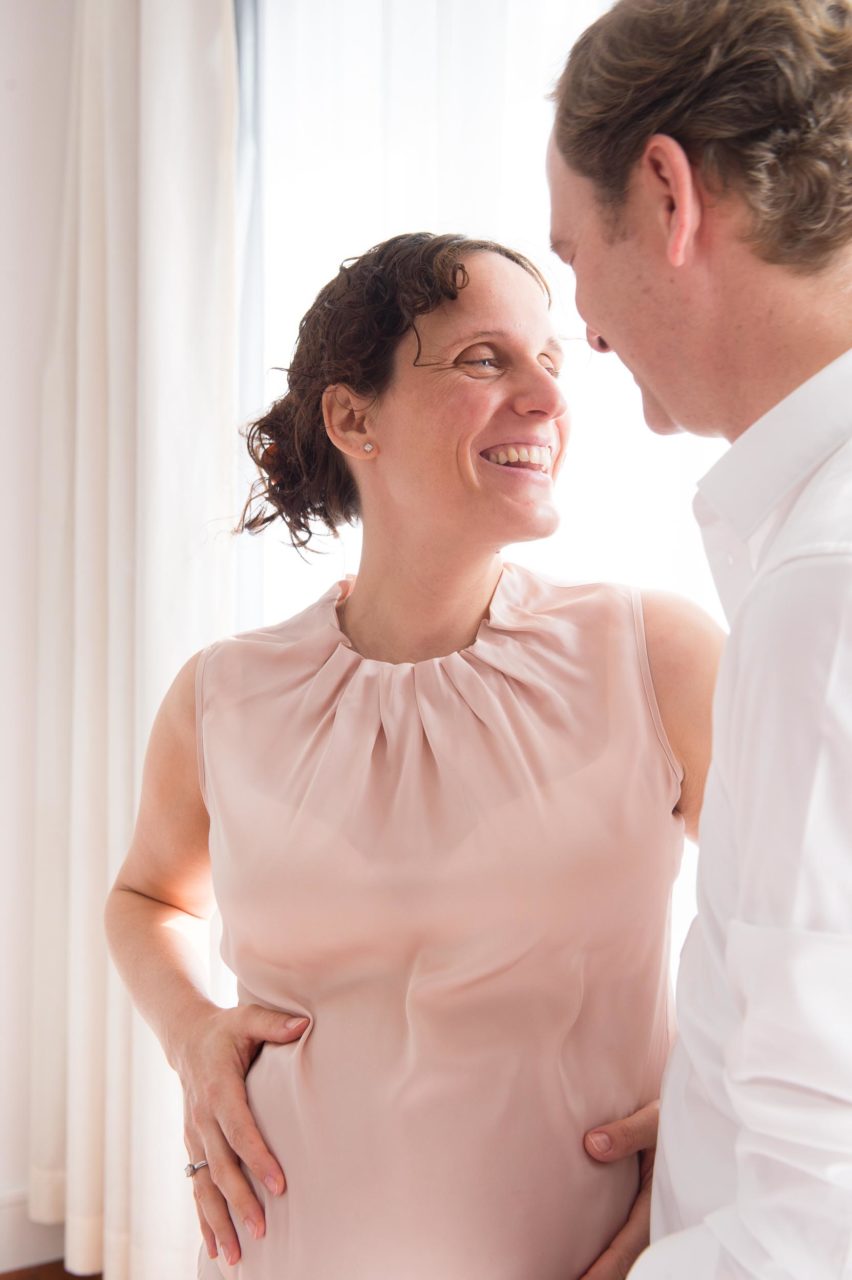 Maternity photoshoot, expecting couple laughing together