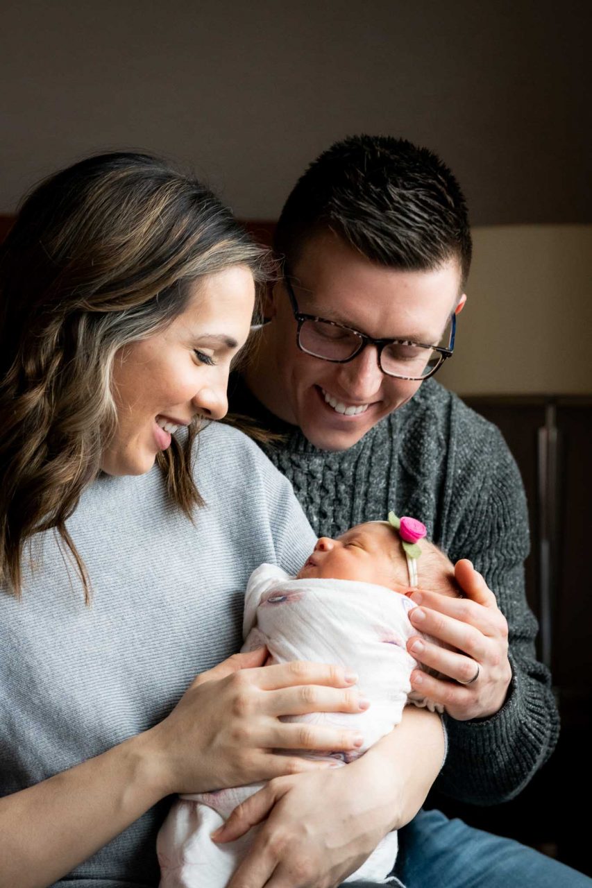 Parents holding their newborn at home