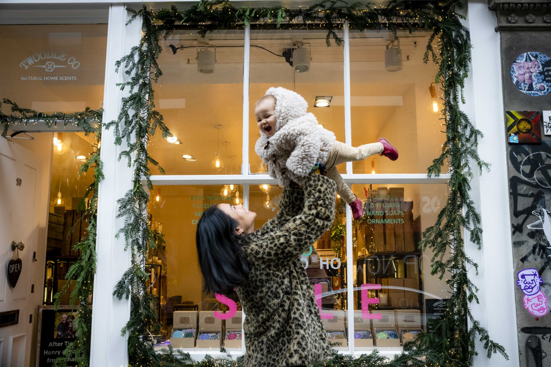 Parent lifting a child on a family shoot in London