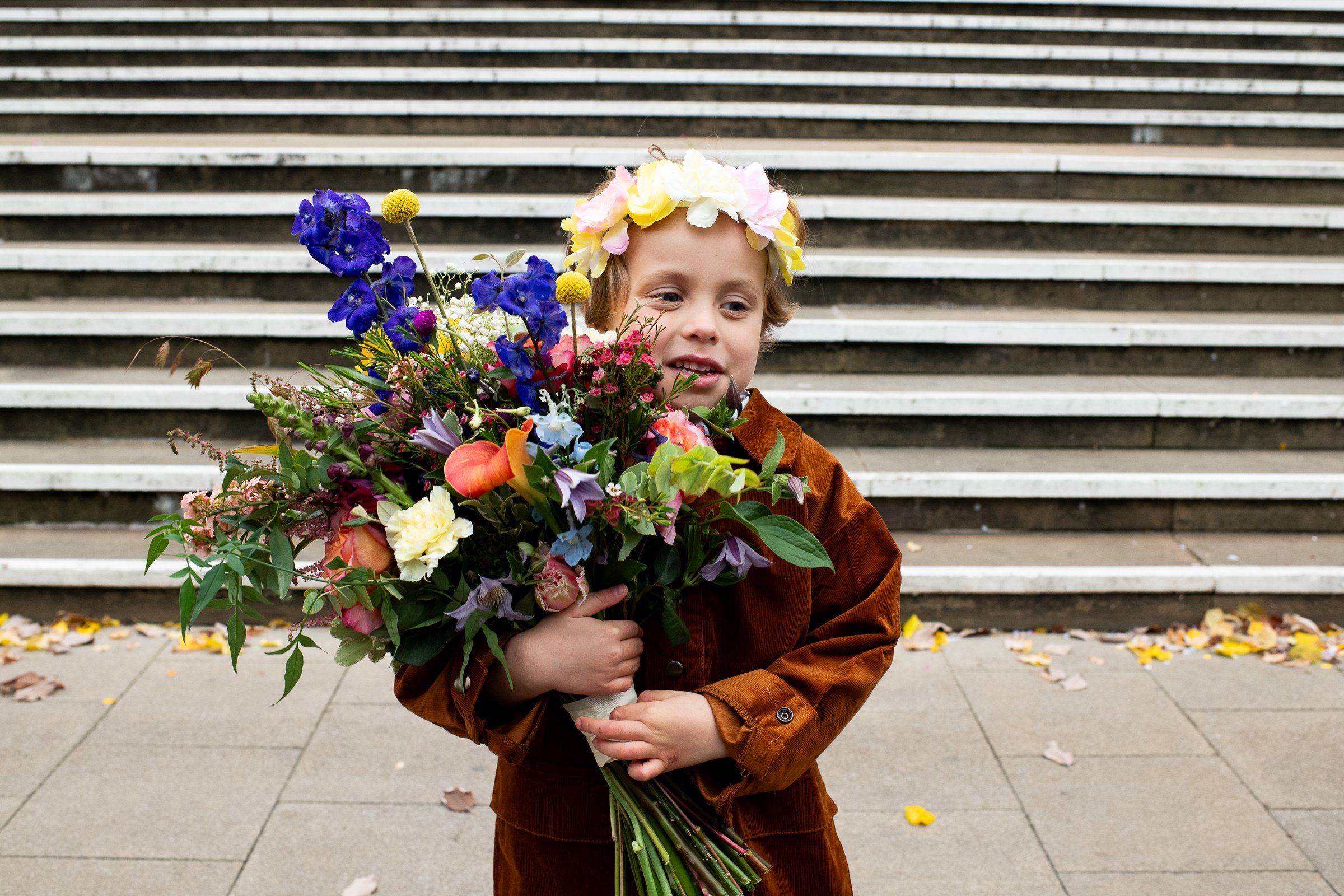 Wedding party celebrating on the steps of Hackney Town Hall