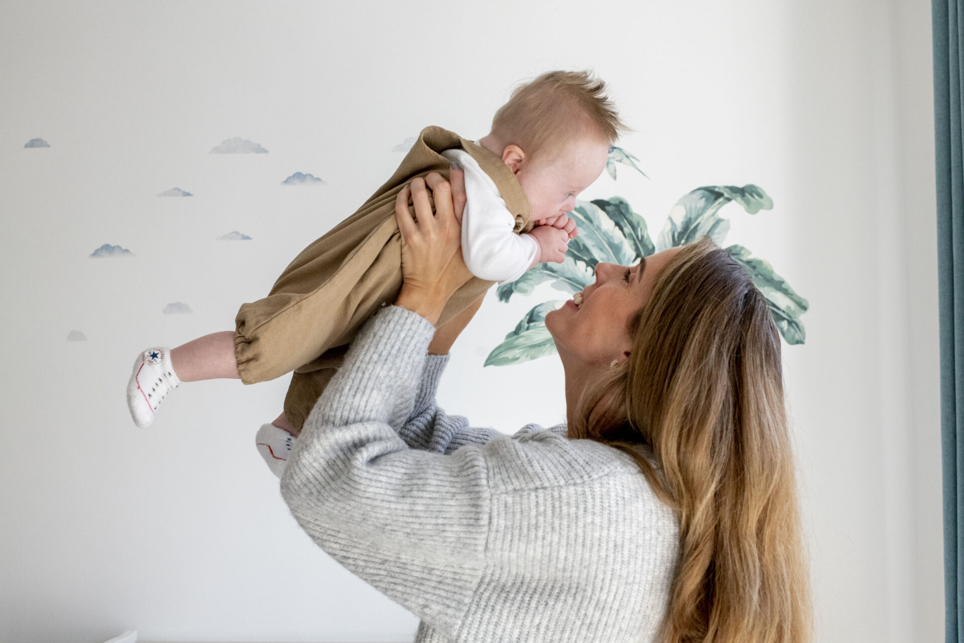 Parent and child by the window on a home shoot in London